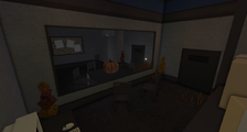 The Halloween version of the rightmost interrogation room, featuring a suspicious pumpkin.